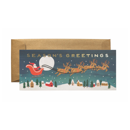 Christmas card with Santa Claus in a sleigh and reindeer over a snowy village, with a gold envelope.
