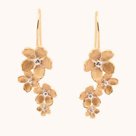 Gold cherry blossom drop earrings with cascading textured flowers and silver-tone centers.