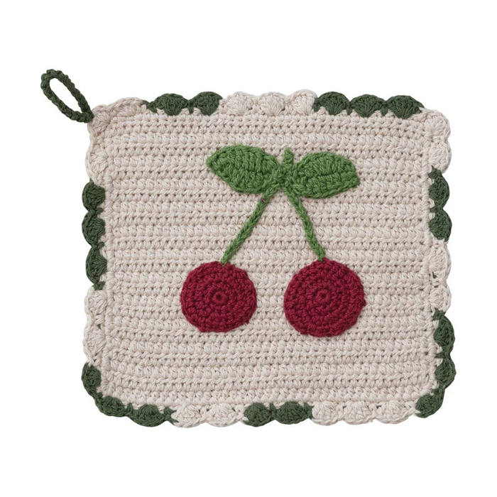 Crocheted pot holder with cherry design on a white background