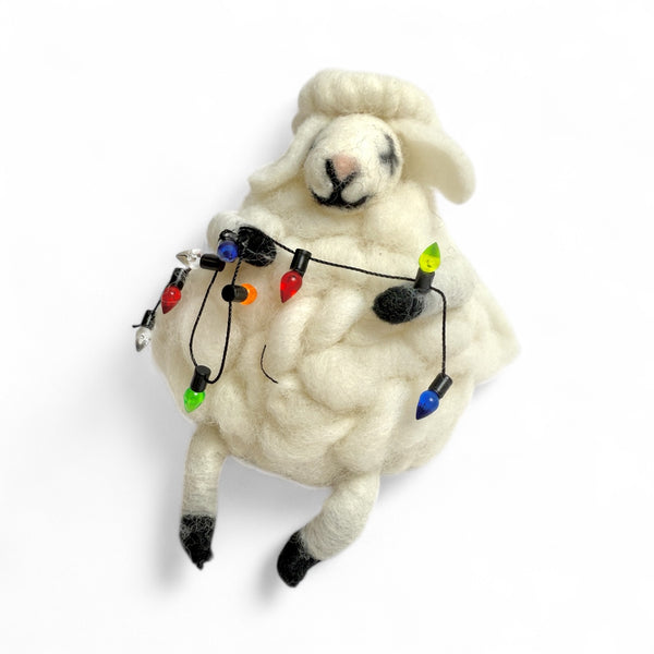 Sheep holding String of lights on a white background