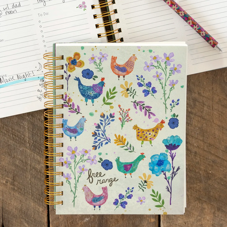 Notebook with floral and chicken design on cover, open to a page with handwritten notes.