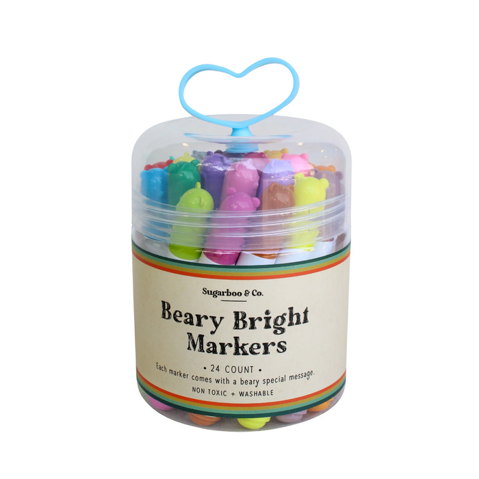 Container of colorful markers with a heart-shaped hook on a white background
