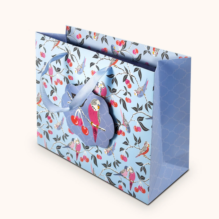 Gift bag with bird and cherry design on a white background