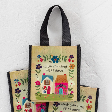 Decorative bag with house illustration and text on a white background