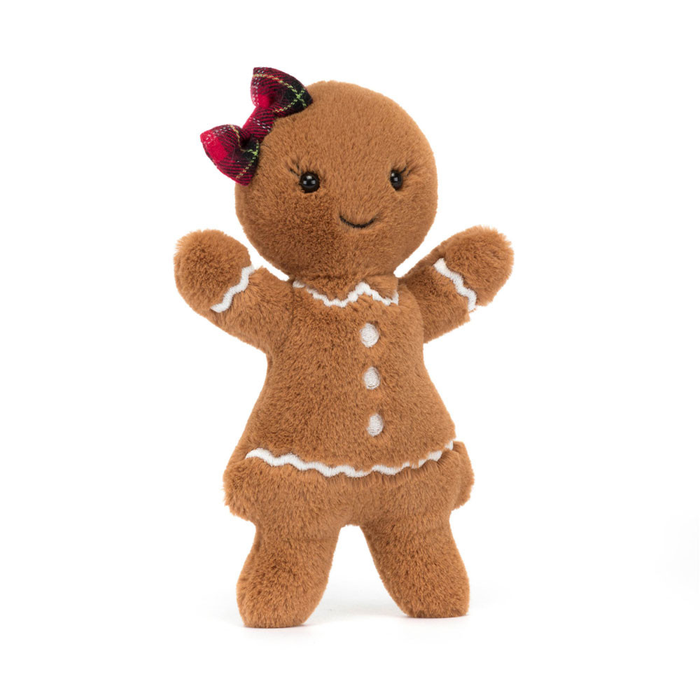 Plush gingerbread toy with a red bow on a white background