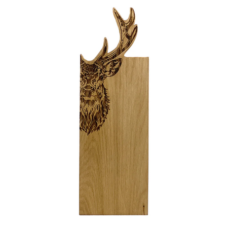 Wooden cutting board with engraved deer head design on a white background