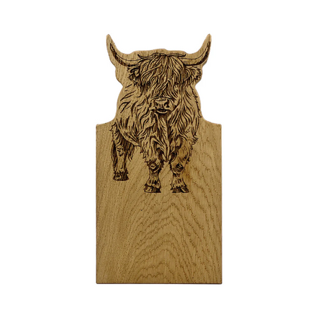 Wooden board with a highland cow engraving on a white background