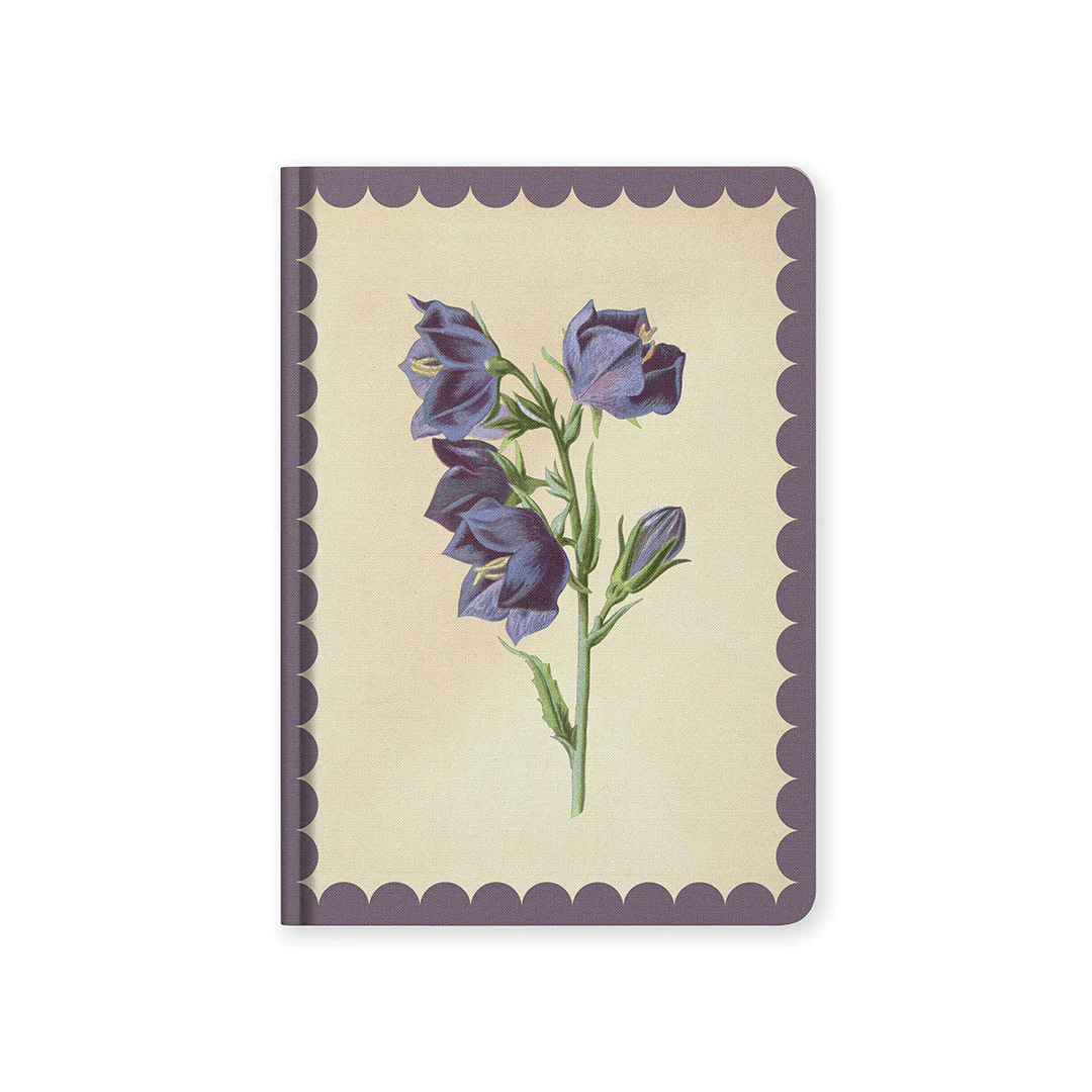 Notebook with purple floral design on a beige background