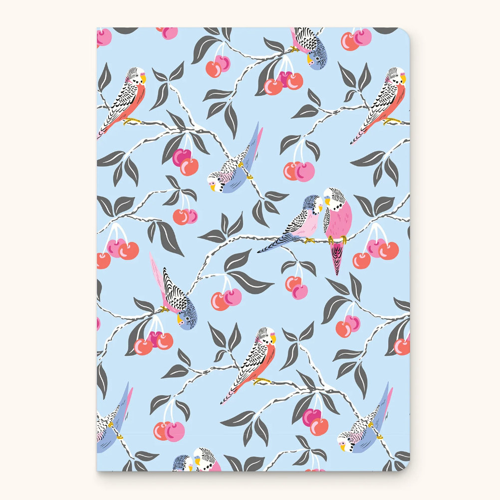 Notebook with bird and cherry pattern on a light blue background