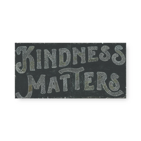 Black sign with 'Kindness Matters' text on a white background