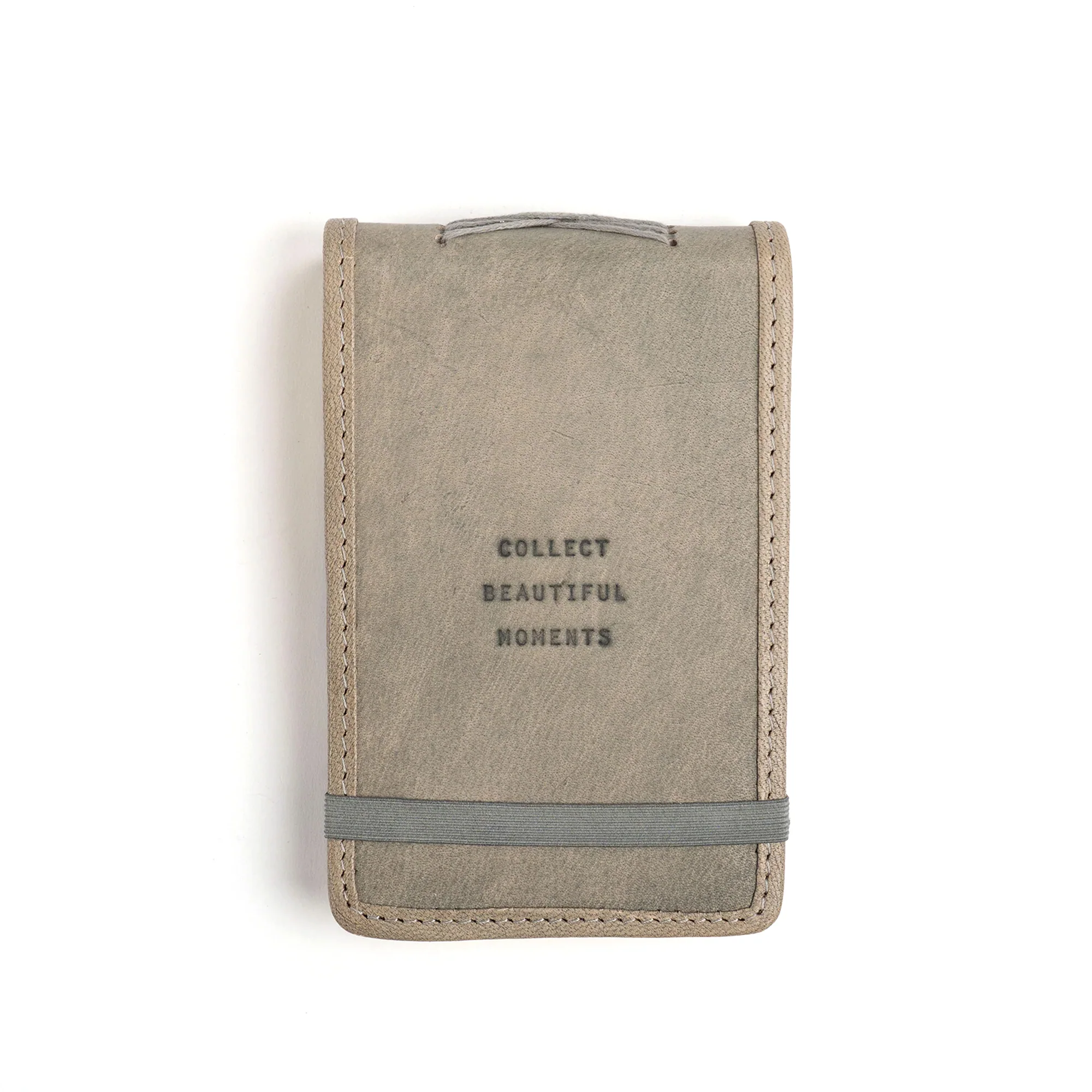 grey stone leather journal with elastic closure. quote on front reads "collect beautiful moments"