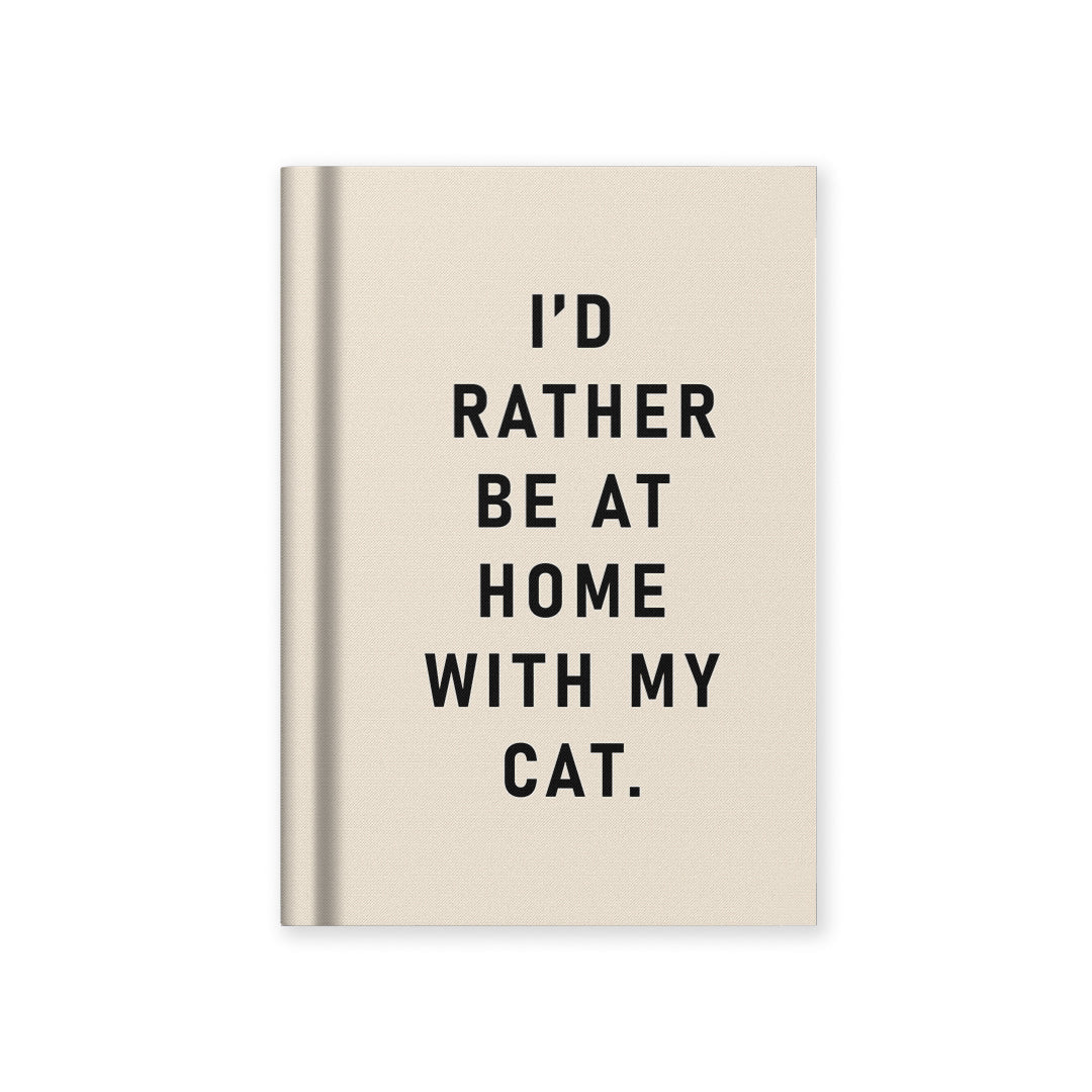 Beige notebook with text 'I'd rather be at home with my cat' on a white background