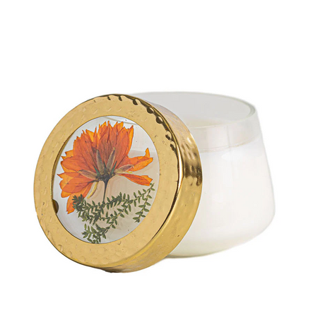 Candle jar with a floral lid on a white background