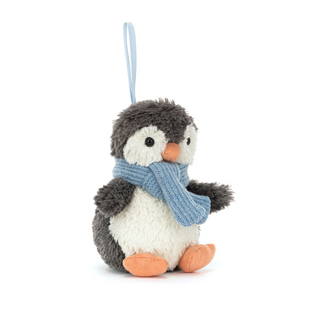 Stuffed penguin ornament with a blue scarf on a white background
