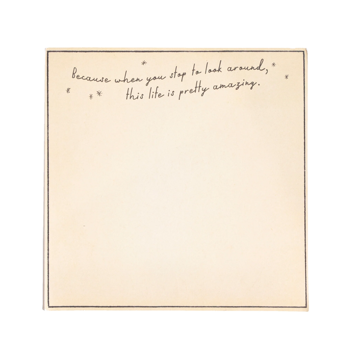 Beige notepad with handwritten text on a white background