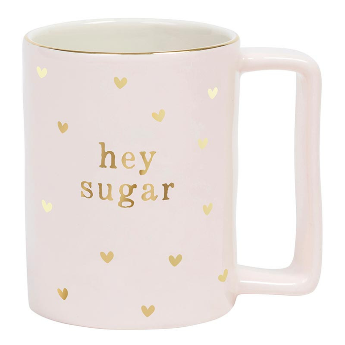 Pink mug with 'hey sugar' text and gold hearts on a white background