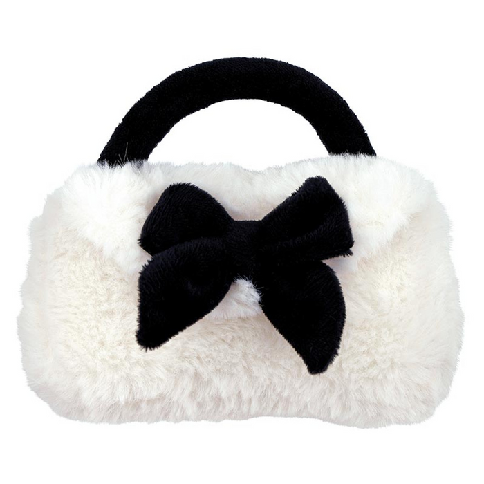 White furry handbag baby rattle with a black bow on a white background