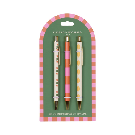 Set of three ballpoint pens with decorative designs in packaging on a white background