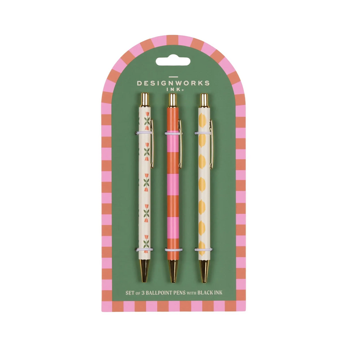 Set of three ballpoint pens with decorative designs in packaging on a white background