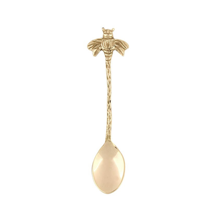 Gold spoon with bee handle on a white background