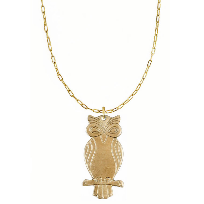 Gold owl pendant necklace on a white background