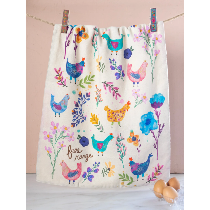 Colorful towel with chicken and flower pattern on a wooden surface