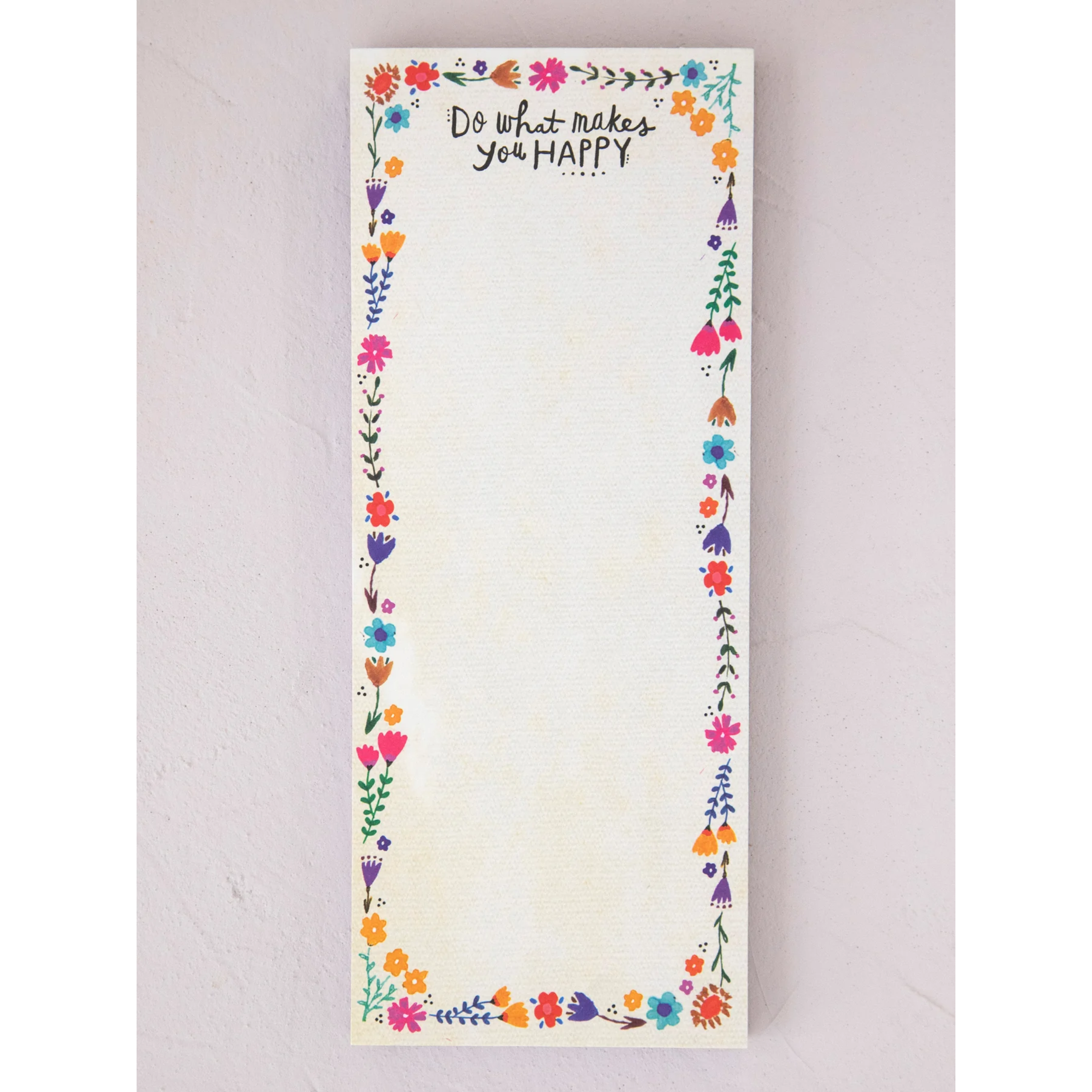Notepad with floral border and motivational quote on a light background