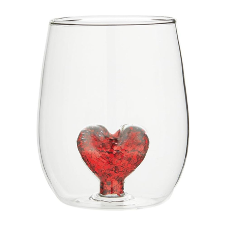 Clear glass with a heart filled with red glitter inside on a white background