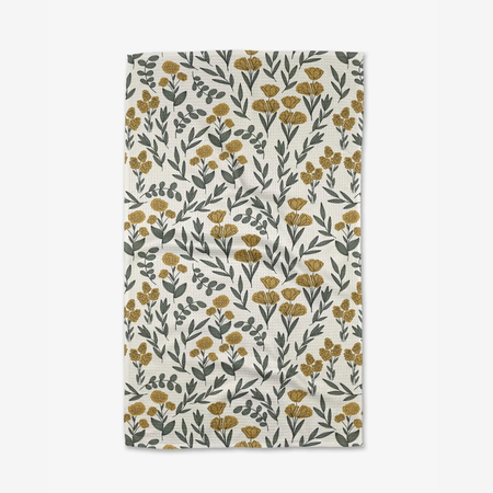 yellow floral tea towel against white background