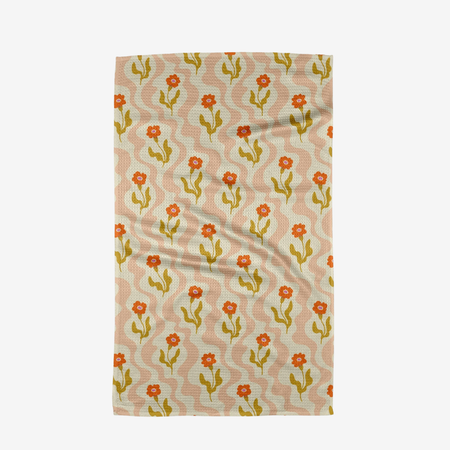 pink and white towel with a red floral design on a white background