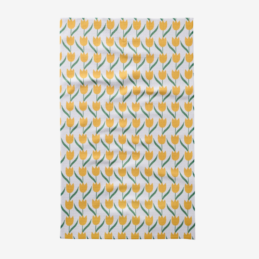 Tea towel with yellow tulip pattern on a white background