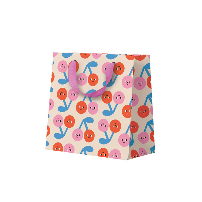 Colorful gift bag with cartoonish designs on a white background