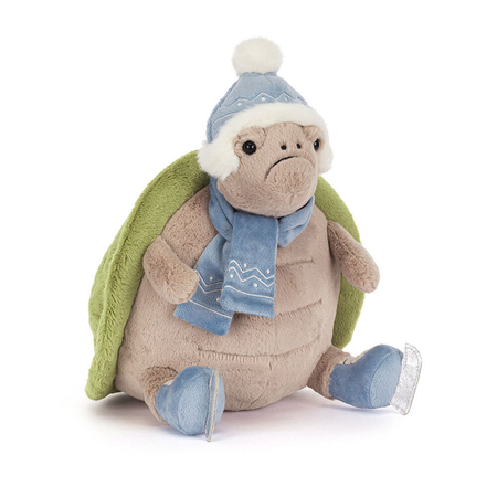 Plush turtle toy wearing a blue hat, scarf, and ice skates on a white background