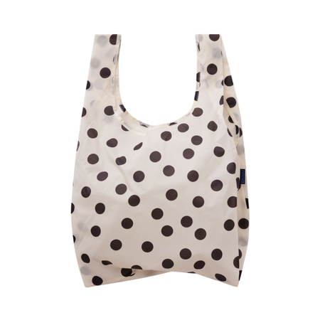A reusable fabric shopping bag with a cream background and dark brown polka dots, shown against a plain white background.