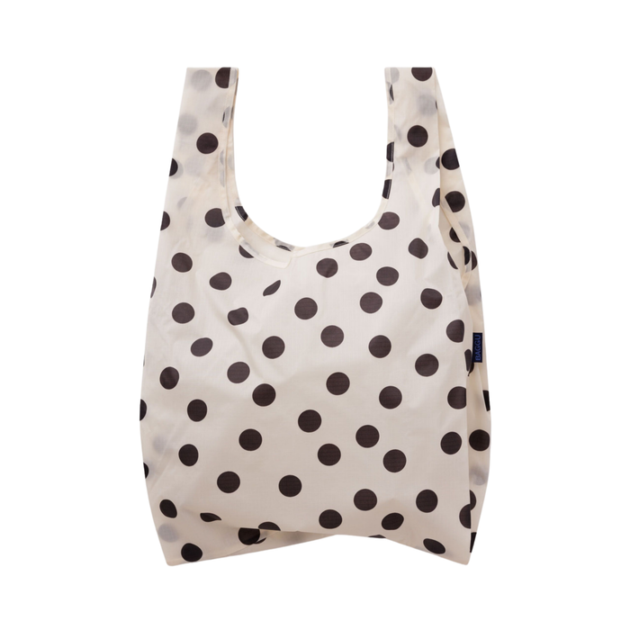A reusable fabric shopping bag with a cream background and dark brown polka dots, shown against a plain white background.
