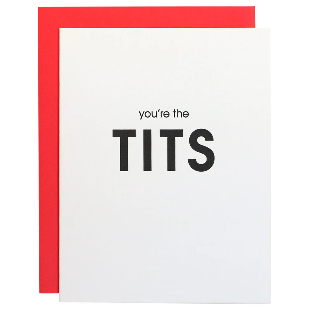 This image features a bold and humorous greeting card titled "You're the Tits". The card is made from bright white, tree-free paper and comes with a neon pink envelope.