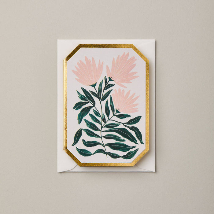 Greeting card with pink flowers and green leaves on a beige background