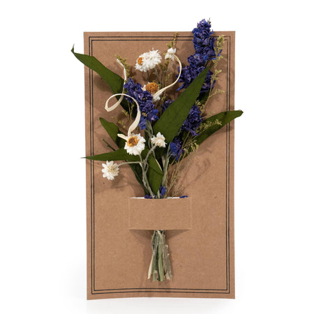 Dried flowers arranged on a brown card with a white background
