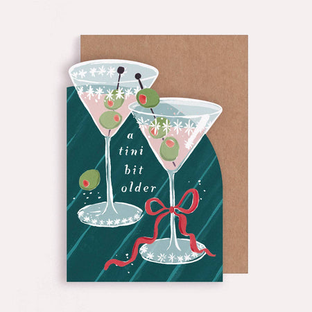Greeting card with illustration of two martini glasses and olives on a green background.