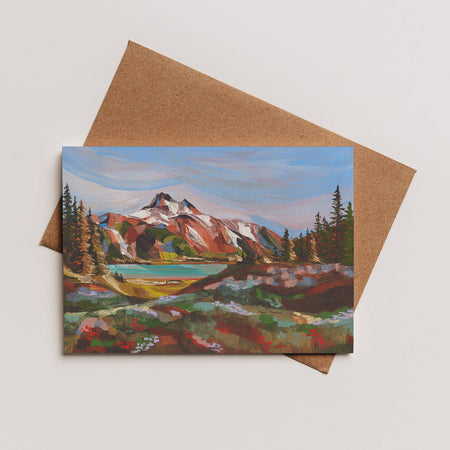 Greeting card with mountain landscape painting on a brown envelope