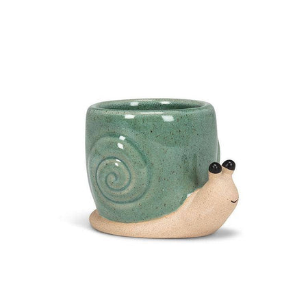 Ceramic snail-shaped mug with green shell on a white background