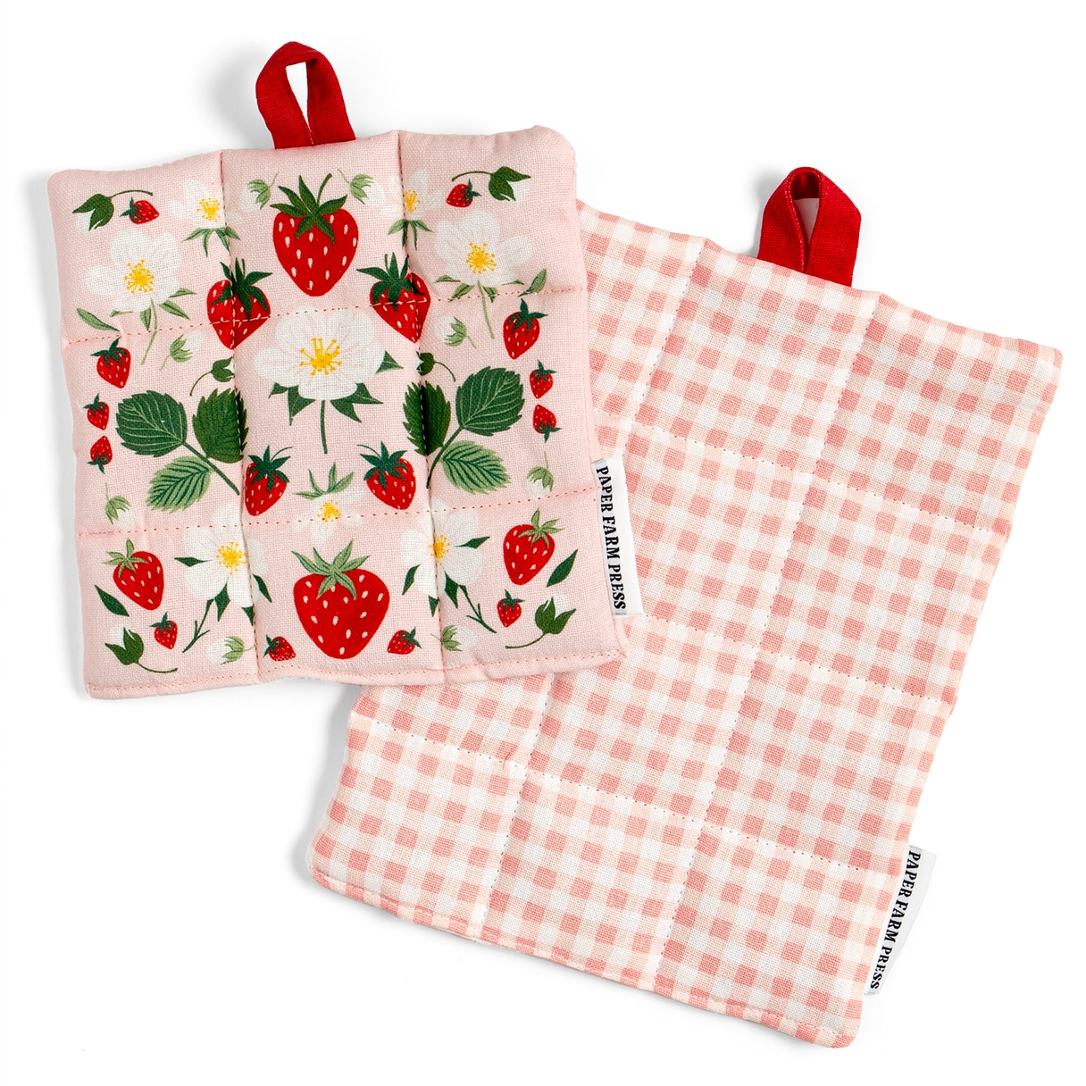 Two quilted fabric potholders from Sweet Farm Fools, displayed on a clean white background. One potholder shows a pink background with a strawberry and white flower pattern, complete with a red hanging loop.