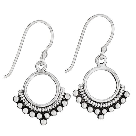 A pair of sterling silver open circle earrings with dotted bottom border and small dangling stones.