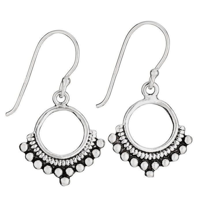 A pair of sterling silver open circle earrings with dotted bottom border and small dangling stones.