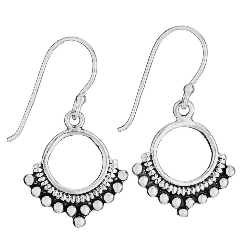 A pair of sterling silver open circle earrings with dotted bottom border and small dangling stones.