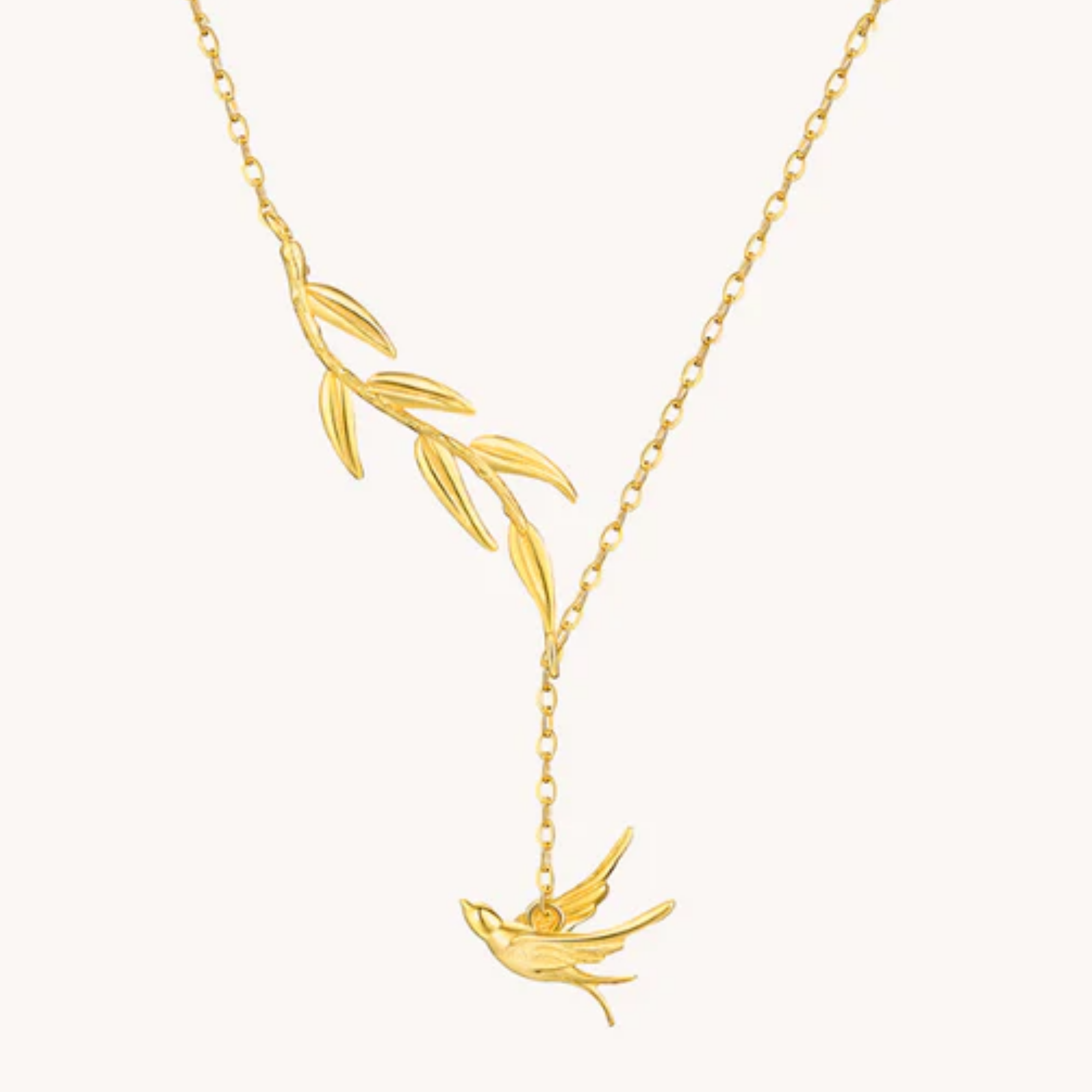 Gold necklace with a bird pendant on a white background