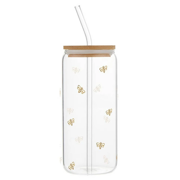Clear glass tumbler with a bamboo lid and clear glass straw, decorated with small gold and white bee motifs, shown on a white background.