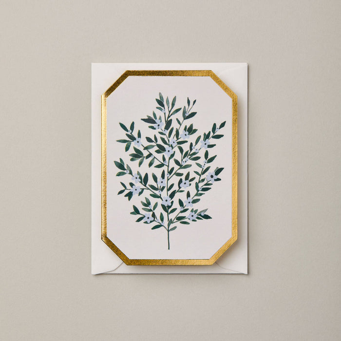 Greeting card with green leaf design and gold border on beige background