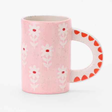 Pink mug with floral pattern on a white background