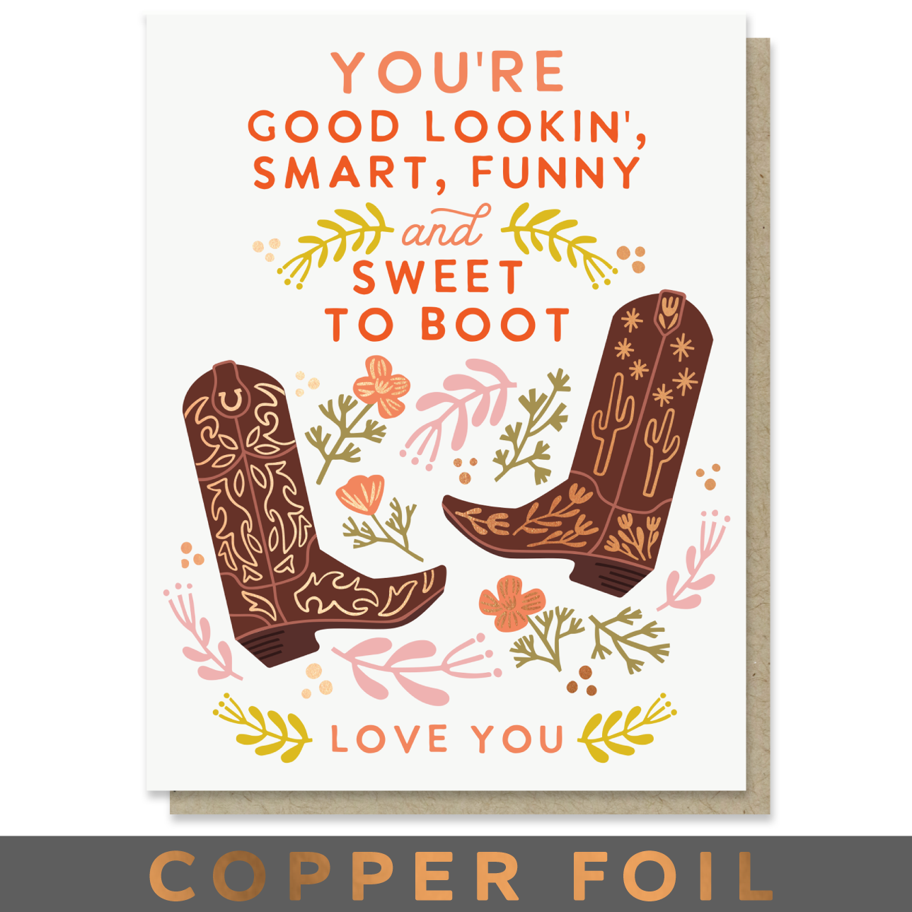 A greeting card with a western theme, featuring the text 'YOU'RE GOOD LOOKIN', 'SMART, FUNNY and SWEET TO BOOT' and 'LOVE YOU' in orange lettering, decorated with illustrated brown cowboy boots, flowers, and leaves. A kraft envelope is visible behind the card, and a dark banner at the bottom reads 'COPPER FOIL'.